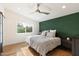 Bright bedroom with wood floors and an accent wall at 3929 E Mercer Ln, Phoenix, AZ 85028