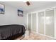 Well-lit bedroom with a full-size bed and large closet at 4129 W Hearn Rd, Phoenix, AZ 85053