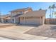 Beige two-story house with a two-car garage and driveway at 4129 W Hearn Rd, Phoenix, AZ 85053