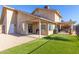 Back exterior view showing patio and grassy yard at 4129 W Hearn Rd, Phoenix, AZ 85053