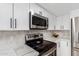 Modern kitchen features stainless steel appliances and white cabinets at 4129 W Hearn Rd, Phoenix, AZ 85053