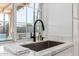 Modern kitchen sink with a sleek black faucet and marble countertop at 4129 W Hearn Rd, Phoenix, AZ 85053