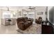 Living room with brown reclining sofas and a large TV at 4129 W Hearn Rd, Phoenix, AZ 85053