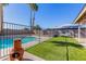 Inviting pool and grassy backyard with a fire pit at 4129 W Hearn Rd, Phoenix, AZ 85053