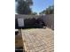 An inviting backyard patio area with brick pavers and a custom rock garden feature at 4714 E Broadway Rd, Phoenix, AZ 85040