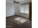 A bright bedroom featuring a ceiling fan, carpet flooring, and natural lighting at 4714 E Broadway Rd, Phoenix, AZ 85040