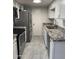 Well-lit kitchen featuring stainless steel appliances, granite countertops, and neutral walls at 4714 E Broadway Rd, Phoenix, AZ 85040