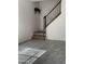 Living room showcasing gray tile flooring, a staircase with black rails, and modern design at 4714 E Broadway Rd, Phoenix, AZ 85040