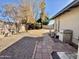 Large backyard with rock landscape, brick walking path, and privacy fence, creating a serene outdoor space at 511 E Port Au Prince Ln, Phoenix, AZ 85022