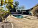 Backyard pool, surrounded by a concrete edge, with a partial view of the home at 511 E Port Au Prince Ln, Phoenix, AZ 85022