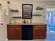 Wet bar features custom cabinetry and sleek shelving adjacent to the sliding glass door at 511 E Port Au Prince Ln, Phoenix, AZ 85022