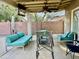 Covered patio with comfortable outdoor furniture, fan, and outdoor television at 511 E Port Au Prince Ln, Phoenix, AZ 85022