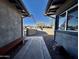 Inviting entryway with a concrete path, a bench, and a view of the neighborhood trees and blue skies at 511 E Port Au Prince Ln, Phoenix, AZ 85022