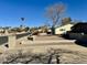 Street view showcasing a well-maintained home with mature trees and desert landscaping at 511 E Port Au Prince Ln, Phoenix, AZ 85022