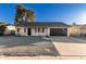 Updated single-story home with modern garage door and gravel landscaping at 5315 W Christy Dr, Glendale, AZ 85304