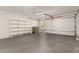 Garage with overhead door, storage shelves, and extra space at 5315 W Christy Dr, Glendale, AZ 85304