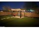 Backyard pergola with outdoor furniture and string lights, creating a cozy ambiance at night at 55 N Abalone Ct, Gilbert, AZ 85233