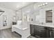 Spacious bathroom featuring dual sinks, mirrors, and a soaking tub at 55 N Abalone Ct, Gilbert, AZ 85233