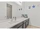 Bright bathroom featuring a long vanity with sink and decorative nautical-themed accents at 55 N Abalone Ct, Gilbert, AZ 85233