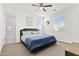 Comfortable bedroom featuring a ceiling fan and natural light from multiple windows at 55 N Abalone Ct, Gilbert, AZ 85233