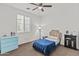 A cozy bedroom with a ceiling fan and bright window at 55 N Abalone Ct, Gilbert, AZ 85233