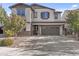 Charming two-story home with a brick paved driveway and neutral colored stucco at 55 N Abalone Ct, Gilbert, AZ 85233