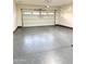 Clean garage featuring a gray epoxy floor with decorative flecks and a white garage door at 55 N Abalone Ct, Gilbert, AZ 85233