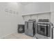 Modern laundry room with stainless steel appliances and stylish decor at 55 N Abalone Ct, Gilbert, AZ 85233