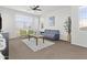 Bright living room with a ceiling fan, sofa, and window with blinds at 55 N Abalone Ct, Gilbert, AZ 85233