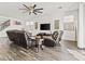 Spacious living room featuring hardwood floors, a ceiling fan, and two leather sofas at 55 N Abalone Ct, Gilbert, AZ 85233