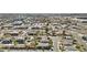 Panoramic aerial view of a residential area with houses, roads, trees, commercial area, and a pond at 55 N Abalone Ct, Gilbert, AZ 85233