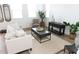 Living Room with a beige sofa, coffee table, and decorative plants at 5814 S Daisy Patch Pl, Phoenix, AZ 85040