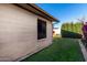 Partial view of backyard with grassy area and block wall at 6258 E Ivy St, Mesa, AZ 85205