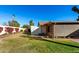 Backyard view of home, storage shed, and landscaping at 6258 E Ivy St, Mesa, AZ 85205