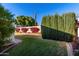 Backyard with landscaping, wall, and grassy area at 6258 E Ivy St, Mesa, AZ 85205