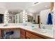 Vanity area with double sinks, lighted mirrors, and tile flooring at 6258 E Ivy St, Mesa, AZ 85205