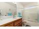 Bathroom with wood vanity, tub, and shower at 6258 E Ivy St, Mesa, AZ 85205