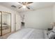 Bedroom with mirrored closet and view into another room at 6258 E Ivy St, Mesa, AZ 85205