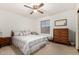 Bedroom with double bed, dresser, and ceiling fan at 6258 E Ivy St, Mesa, AZ 85205