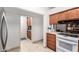 Updated kitchen with wood cabinets and a view into the dining area at 6258 E Ivy St, Mesa, AZ 85205