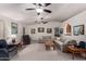 Bright living room with sectional sofa and two ceiling fans at 6258 E Ivy St, Mesa, AZ 85205