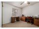 Home office with wood desk, chair, and ceiling fan at 6258 E Ivy St, Mesa, AZ 85205