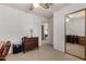 Office space with wood desk, chair, and mirrored closet at 6258 E Ivy St, Mesa, AZ 85205