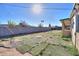 Large backyard with patchy grass and dirt areas at 6649 W Orange Dr, Glendale, AZ 85301