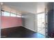 A bedroom with pink walls, a door to the exterior, and a ceiling fan at 6649 W Orange Dr, Glendale, AZ 85301