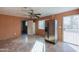 Simple kitchen with wood paneling, a refrigerator, and a ceiling fan at 6649 W Orange Dr, Glendale, AZ 85301