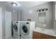 Laundry room features washer, dryer, and a sink with cabinets at 6649 W Orange Dr, Glendale, AZ 85301