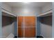 Storage room with wooden cabinets and overhead shelving at 6649 W Orange Dr, Glendale, AZ 85301