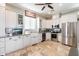 Modern kitchen with white cabinets, stainless steel appliances, and farmhouse sink at 6708 E Calle De Las Estrellas Rd, Cave Creek, AZ 85331