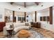 Living room with curved sectional sofa and wood beam ceiling at 6708 E Calle De Las Estrellas Rd, Cave Creek, AZ 85331